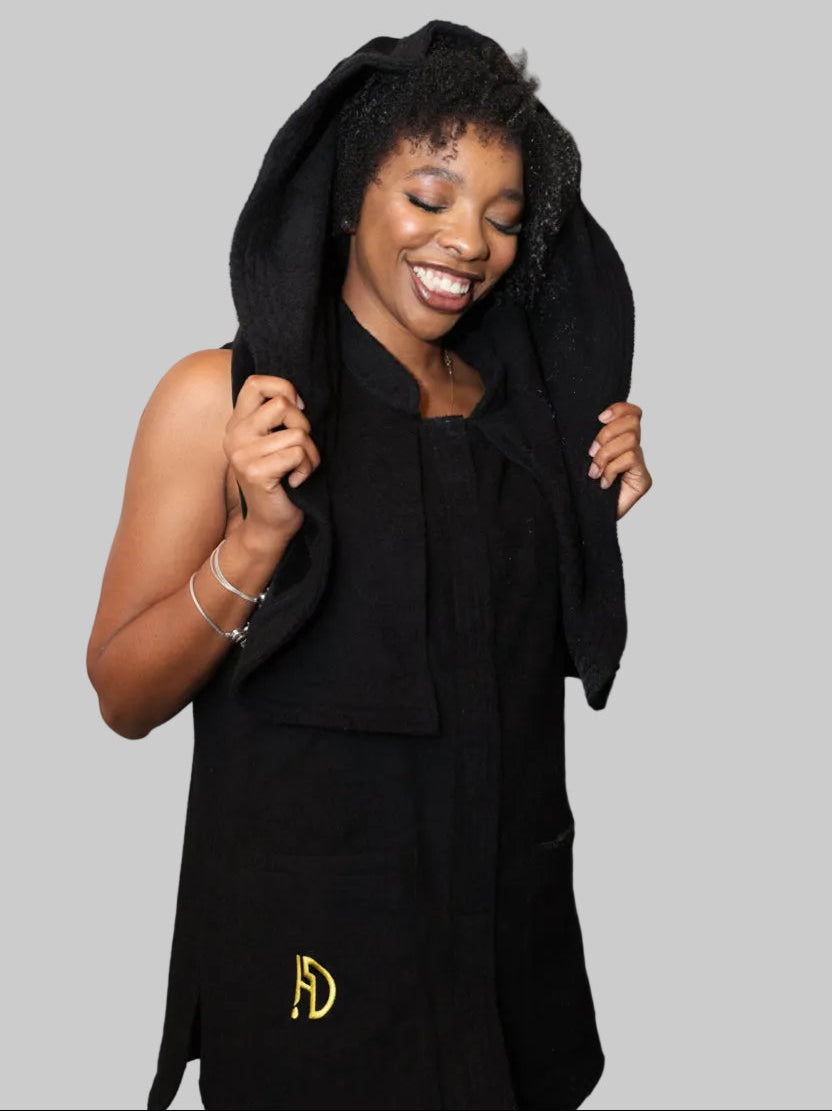 A woman wearing black premium hairdrip wear towel garment.